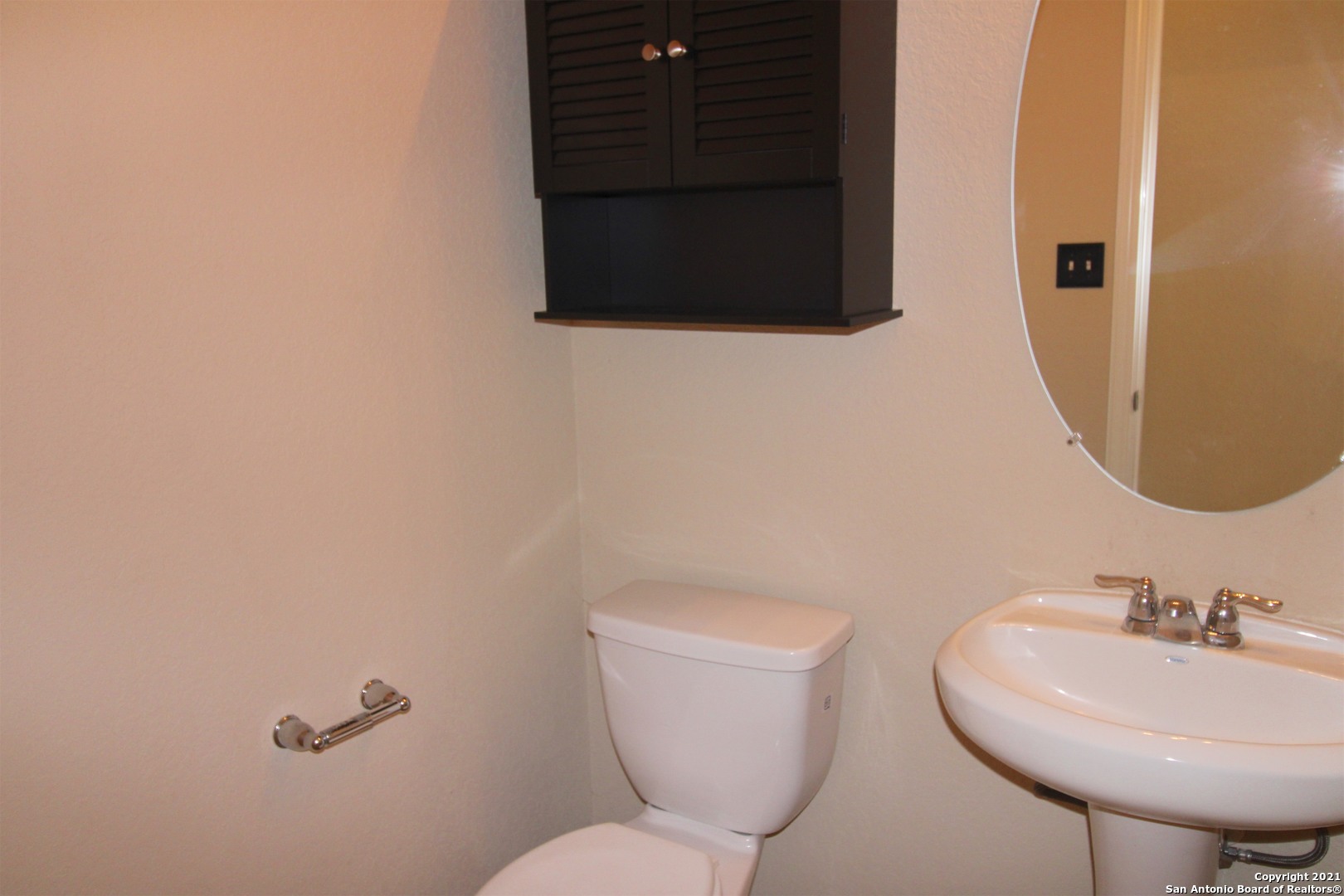 9118 Hogarten Converse, TX 78109 - Photo 23 of 26 a bathroom with a toilet sink and mirror