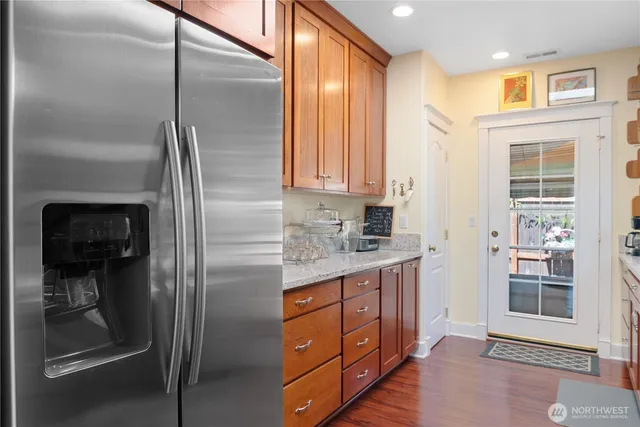 a kitchen with stainless steel appliances granite countertop a refrigerator and a stove