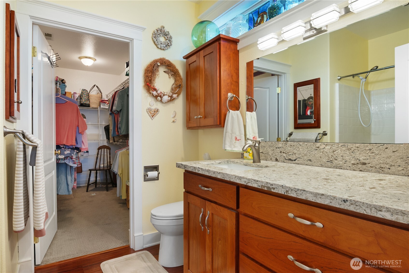 5562 Solo Point Drive Longview, WA 98632 - Photo 17 of 37 a bathroom with a granite countertop sink a toilet and a mirror