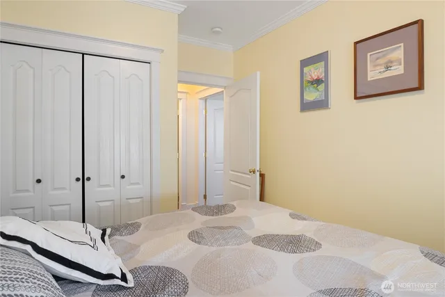 a bedroom with a bed and a chandelier