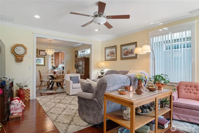 a dining room with furniture a rug and a chandelier