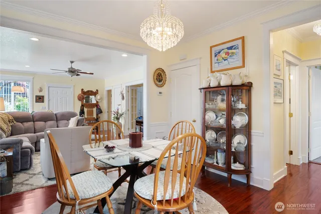 a view of a dining room with furniture wooden floor and chandelier