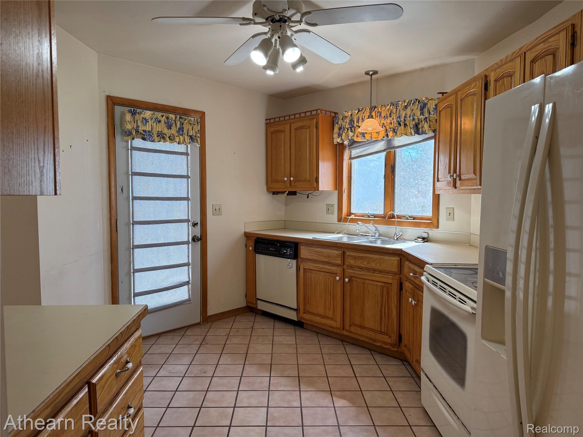 11449 Torrey Road Fenton, MI 48430 - Photo 12 of 30 Kitchen featuring wood cabinetry, white appliances, a ceiling fan with integrated lighting, and tiled flooring