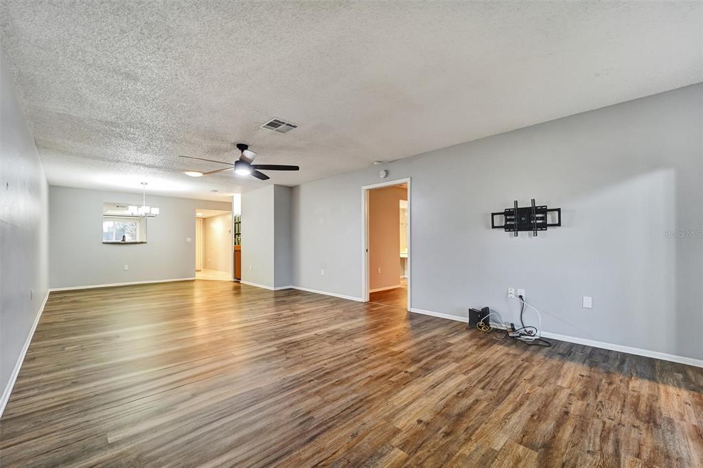 8330 High Point Circle, Unit 6 Port Richey, FL 34668 - Photo 11 of 28 wooden floor in an empty room with a window