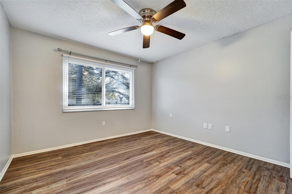 8330 High Point Circle, Unit 6 Port Richey, FL 34668 - Photo 16 of 28 a view of empty room with wooden floor and fan
