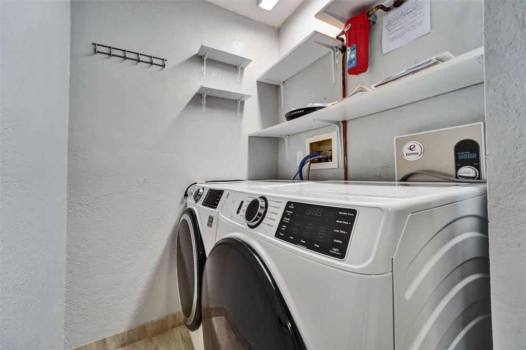 8330 High Point Circle, Unit 6 Port Richey, FL 34668 - Photo 18 of 28 a utility room with dryer and washer