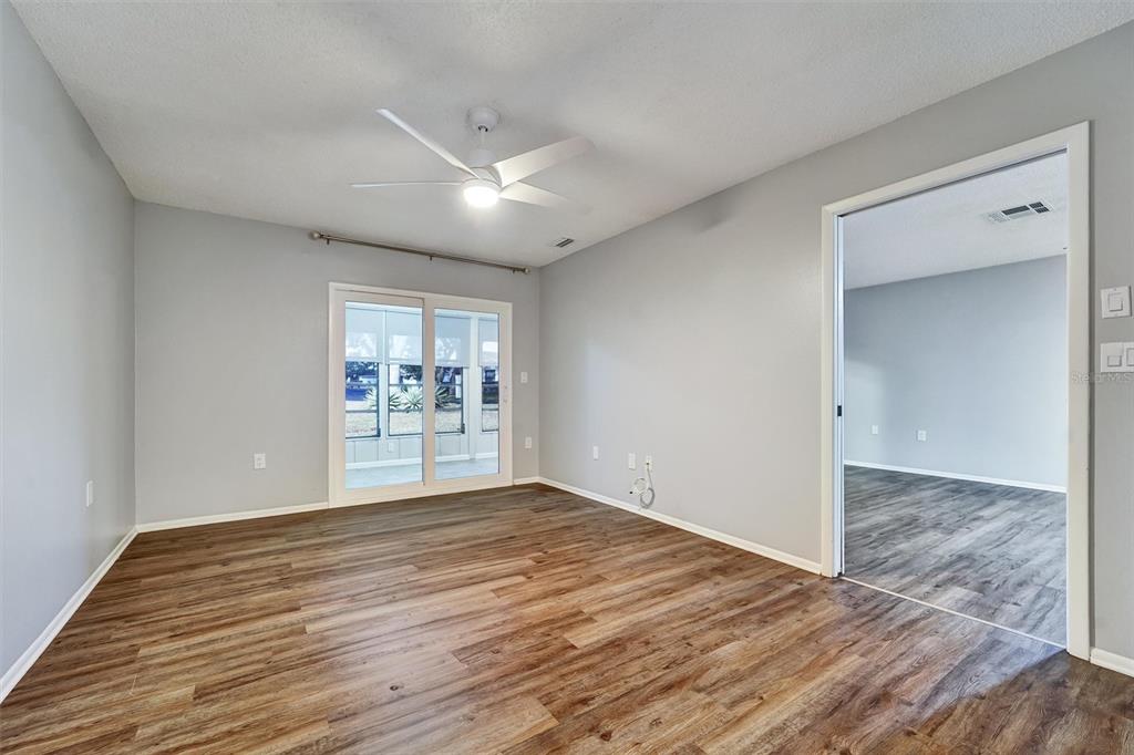 8330 High Point Circle, Unit 6 Port Richey, FL 34668 - Photo 19 of 28 a view of an empty room with a window and wooden floor