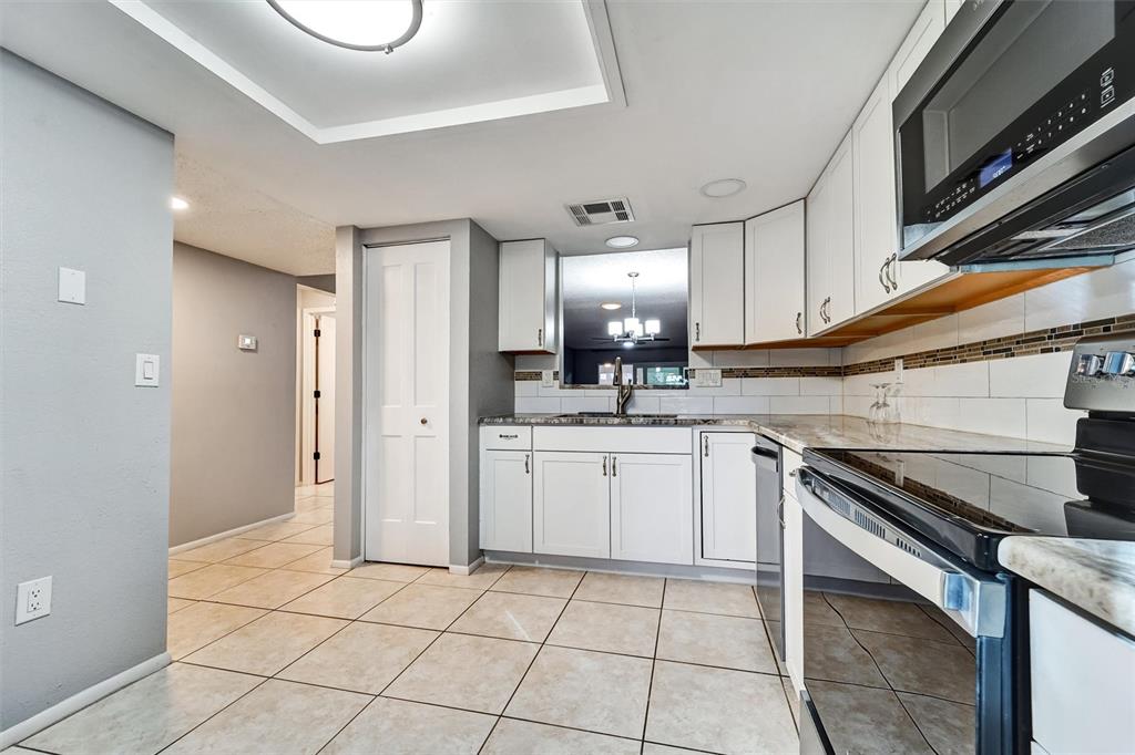 8330 High Point Circle, Unit 6 Port Richey, FL 34668 - Photo 2 of 28 a kitchen with a sink cabinets and stainless steel appliances