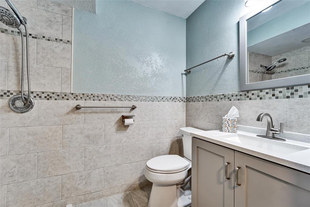 8330 High Point Circle, Unit 6 Port Richey, FL 34668 - Photo 22 of 28 a bathroom with a sink toilet and shower