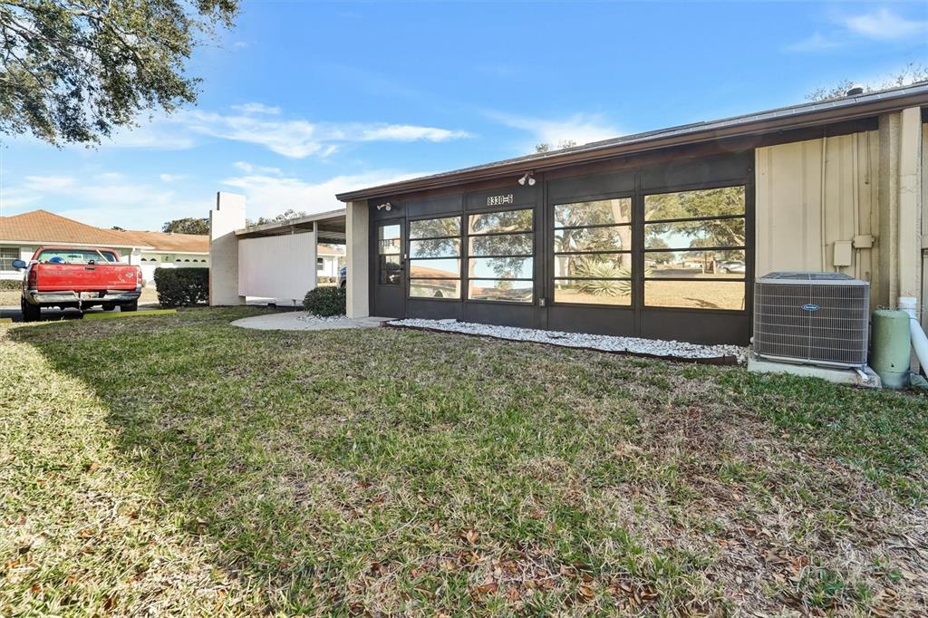 8330 High Point Circle, Unit 6 Port Richey, FL 34668 - Photo 25 of 28 a view of a house with a yard and sitting area