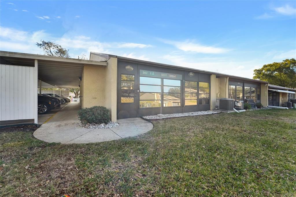 8330 High Point Circle, Unit 6 Port Richey, FL 34668 - Photo 26 of 28 a view of a house with backyard and porch