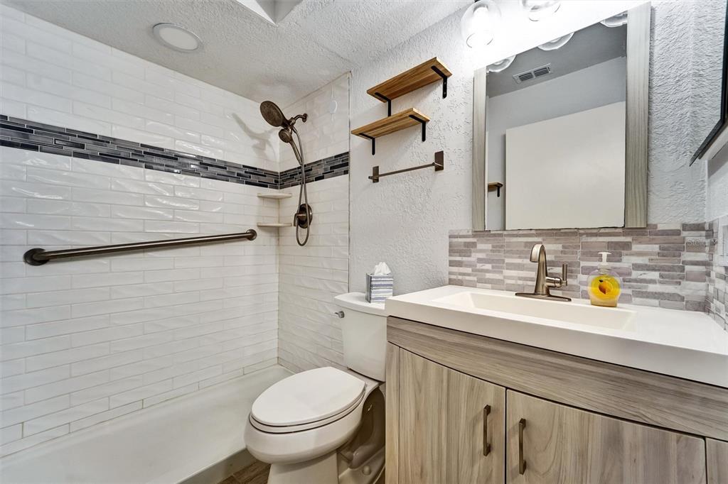 8330 High Point Circle, Unit 6 Port Richey, FL 34668 - Photo 3 of 28 a bathroom with a sink a toilet and shower