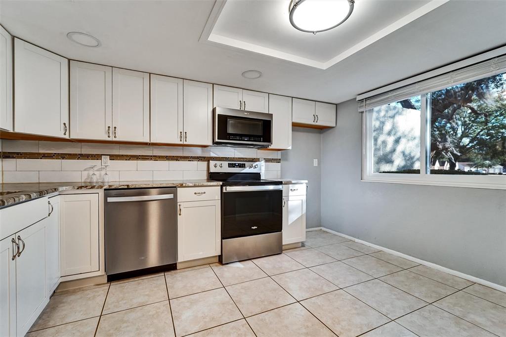 8330 High Point Circle, Unit 6 Port Richey, FL 34668 - Photo 6 of 28 a kitchen with cabinets stainless steel appliances and a window