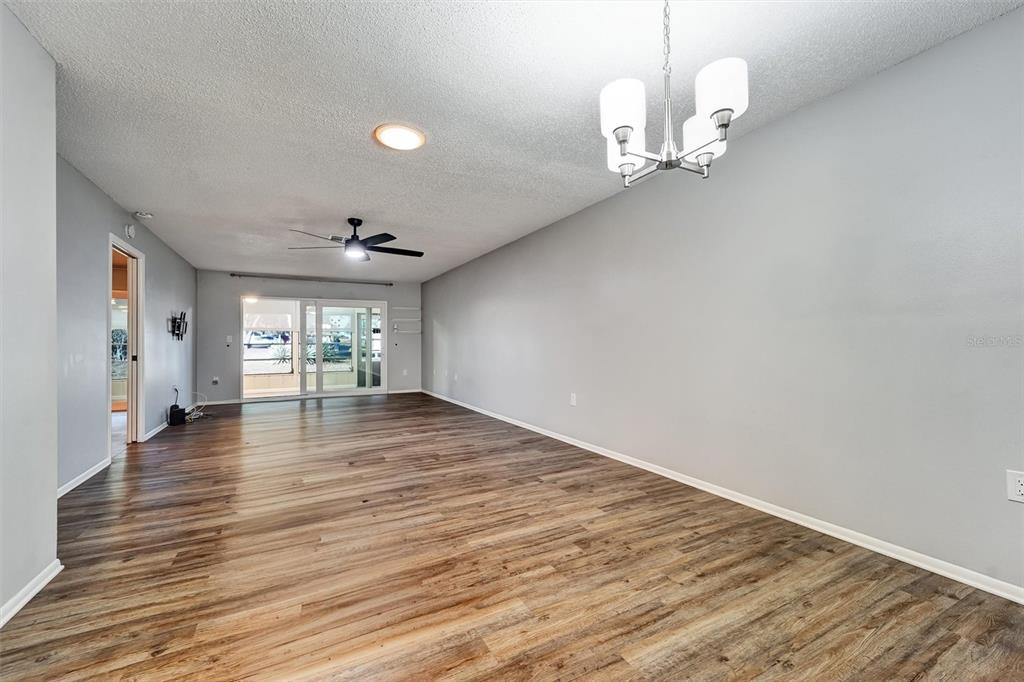 8330 High Point Circle, Unit 6 Port Richey, FL 34668 - Photo 9 of 28 a view of an empty room with wooden floor and a window