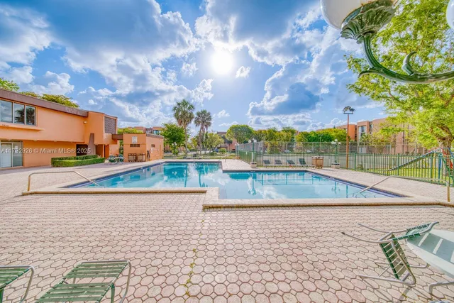 a view of a swimming pool with a yard
