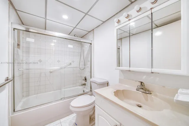 a view of an empty room with window and chandelier fan