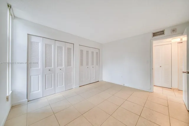 a bathroom with a granite countertop toilet sink and shower