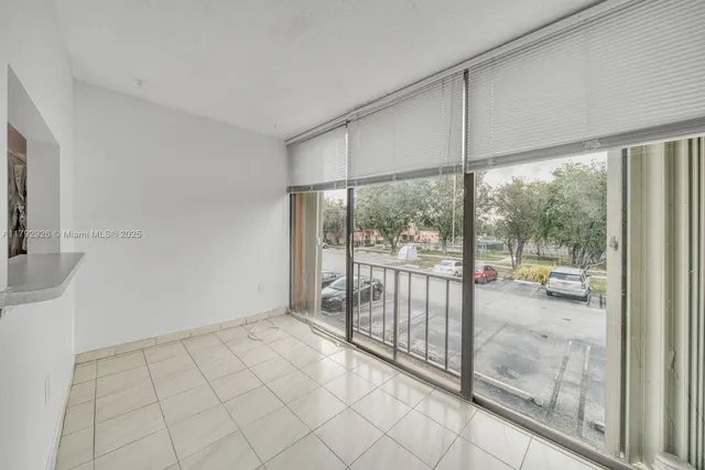 an empty room with windows and ceiling fan