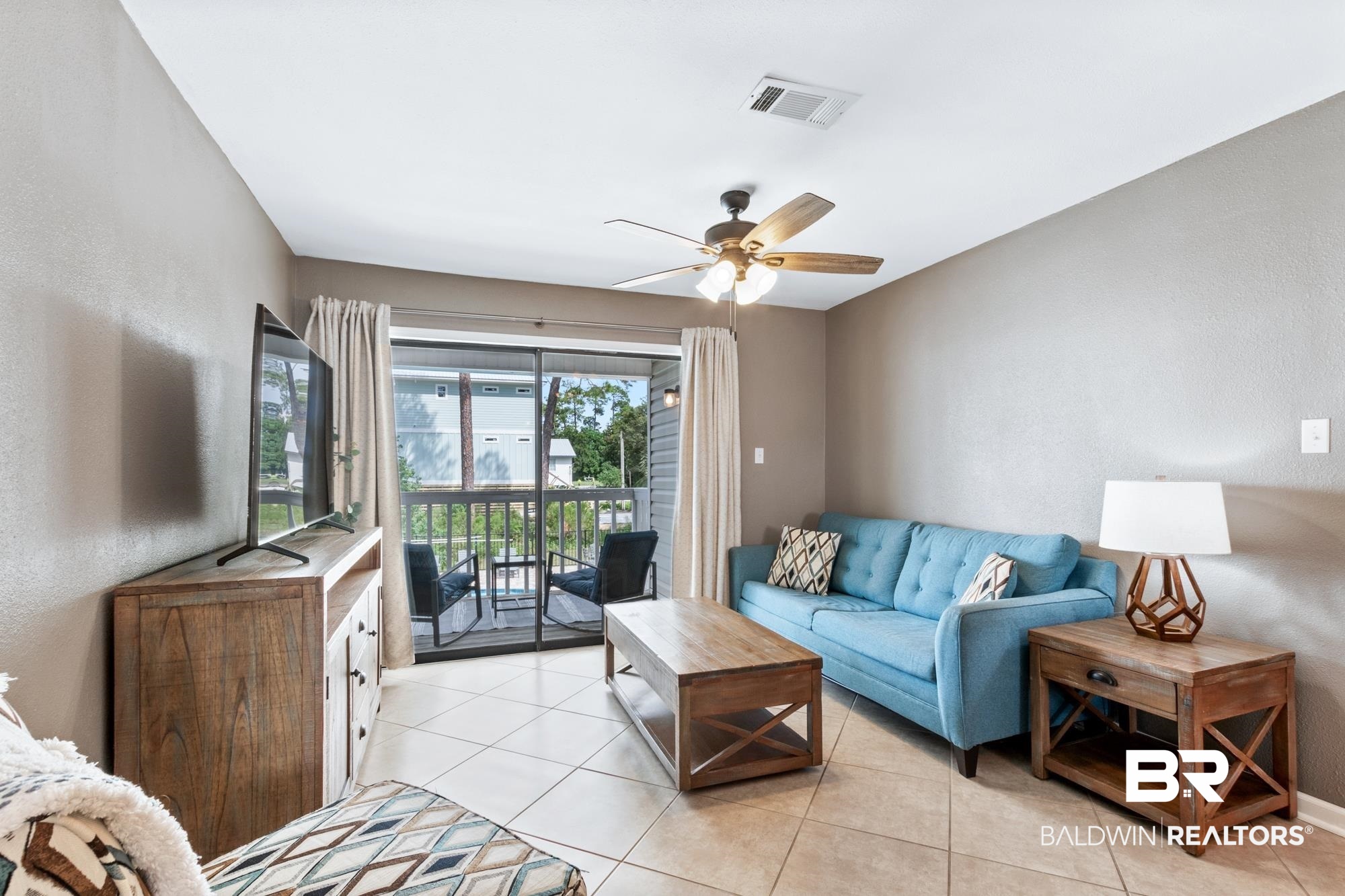 25925 -C Canal Road, Unit 203 Orange Beach, AL 36561 - Photo 10 of 57 Living room with ceiling fan and light tile patterned floors