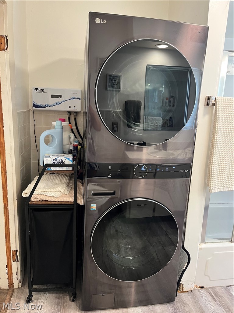 175 Wayne Street Rittman, OH 44270 - Photo 18 of 35 Stacked washer and dryer unit, featuring a water filtration system and tiled wall