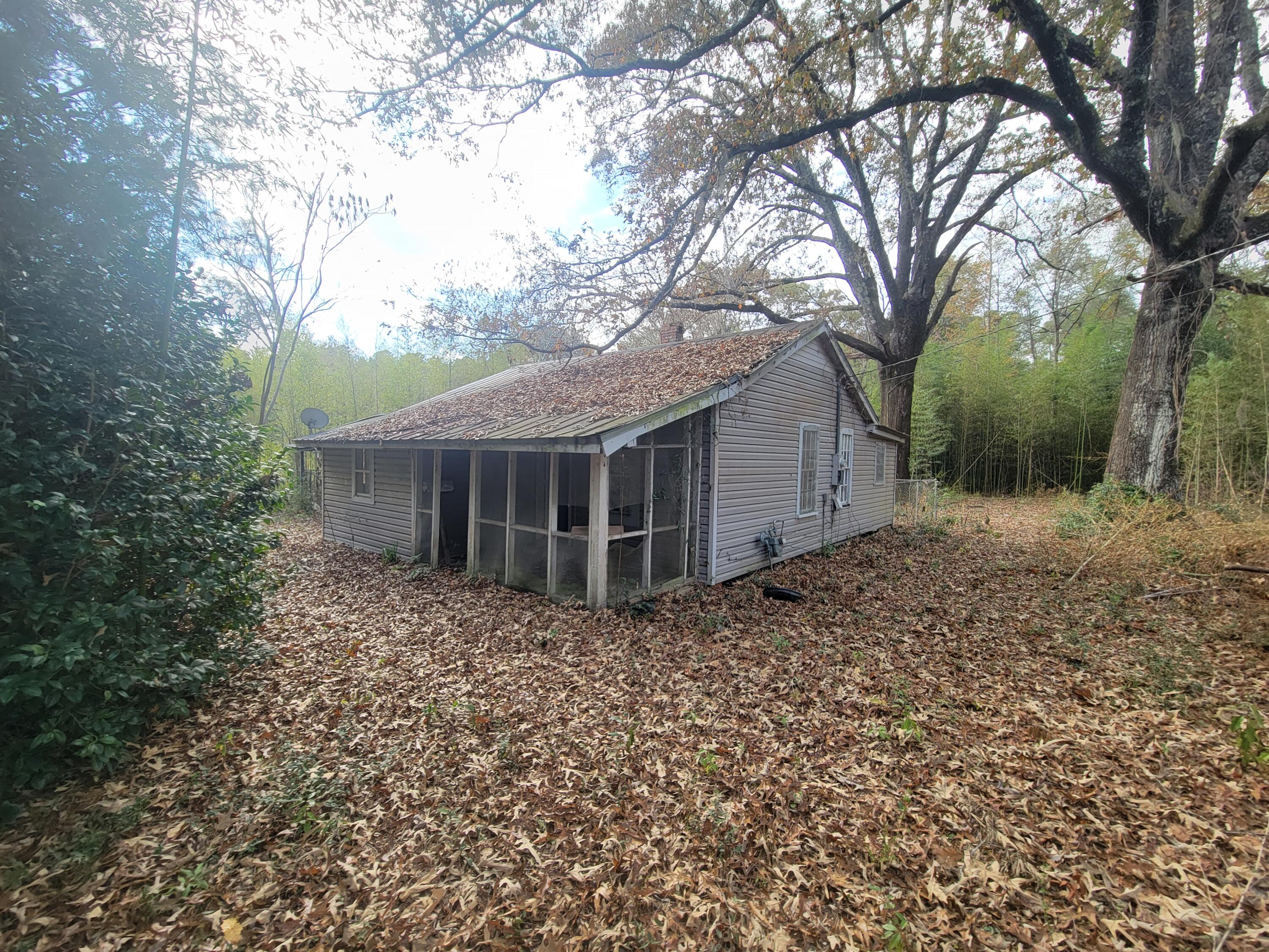 228 Double Bridge Road Laurel Hill, FL 32567 - Photo 19 of 23 a backyard of a house with large trees and wooden fence