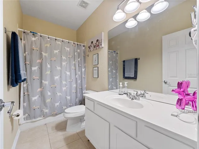 a bathroom with a sink a toilet a tub and shower