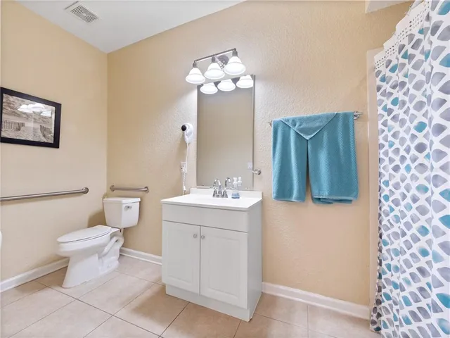 a bathroom with a sink mirror and toilet