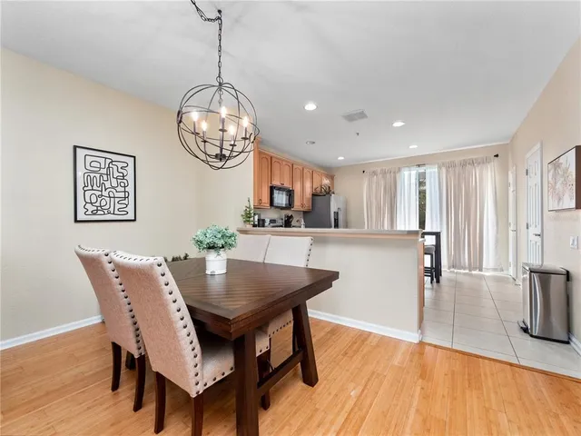 a view of a dining room with furniture wooden floor and chandelier