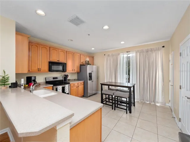 a view of kitchen with microwave and cabinets