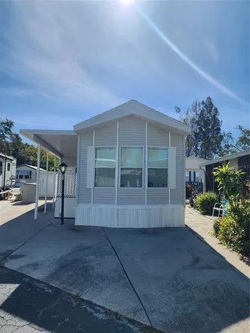 a view of a house with a yard and potted plants