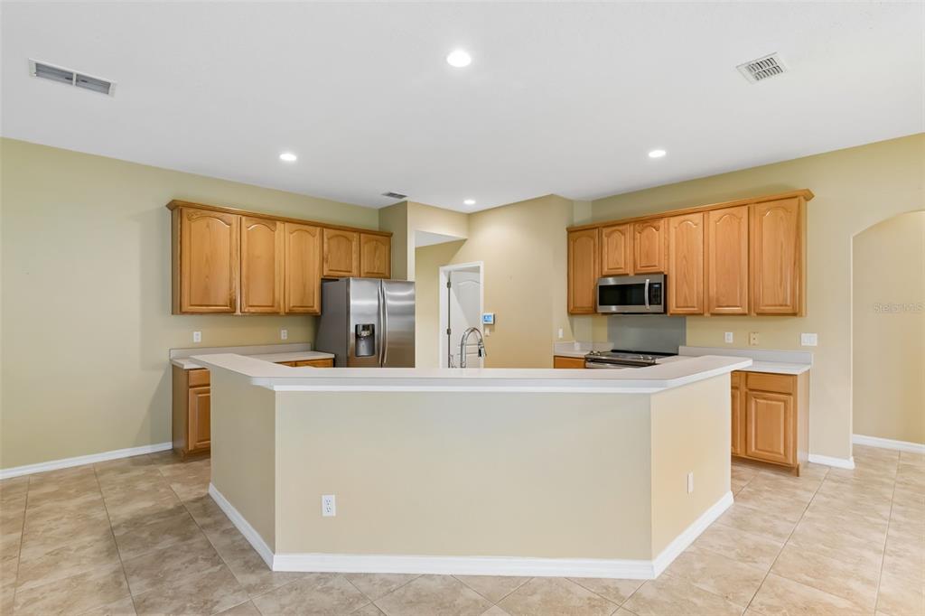 10118 Shortwood Lane Orlando, FL 32836 - Photo 12 of 53 a kitchen with stainless steel appliances a refrigerator and a stove top oven