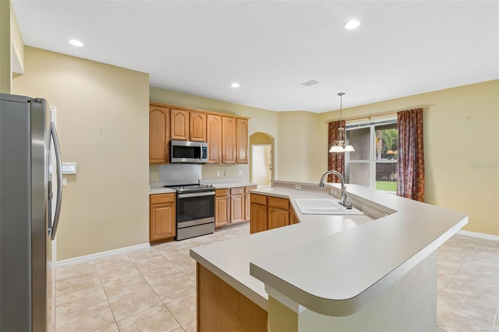 10118 Shortwood Lane Orlando, FL 32836 - Photo 13 of 53 a kitchen with stainless steel appliances granite countertop a sink a stove and a refrigerator