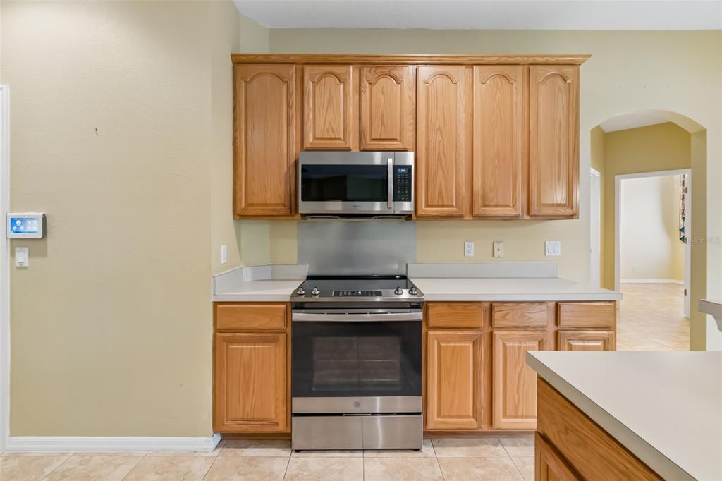 10118 Shortwood Lane Orlando, FL 32836 - Photo 15 of 53 a kitchen with granite countertop white cabinets and stainless steel appliances