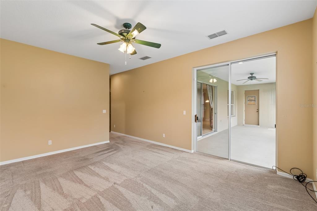 10118 Shortwood Lane Orlando, FL 32836 - Photo 19 of 53 a view of an empty room with a ceiling fan
