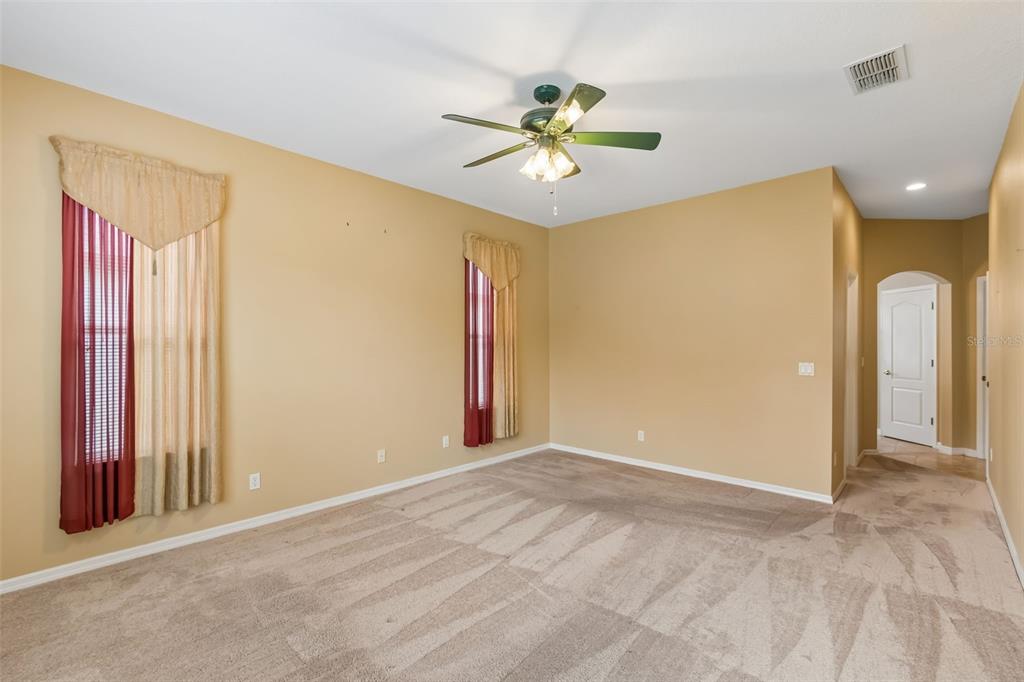 10118 Shortwood Lane Orlando, FL 32836 - Photo 20 of 53 an empty room with windows and fan chandelier