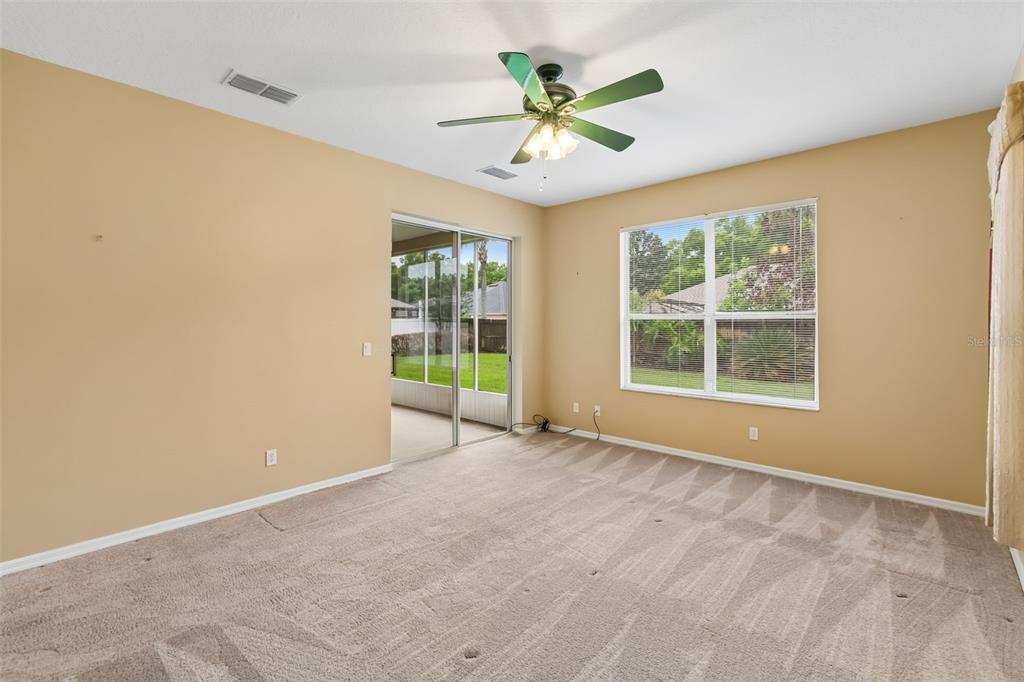 10118 Shortwood Lane Orlando, FL 32836 - Photo 21 of 53 an empty room with windows and ceiling fan