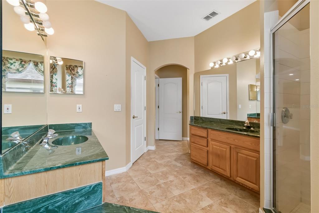 10118 Shortwood Lane Orlando, FL 32836 - Photo 23 of 53 a large bathroom with a granite countertop sink a mirror and a shower