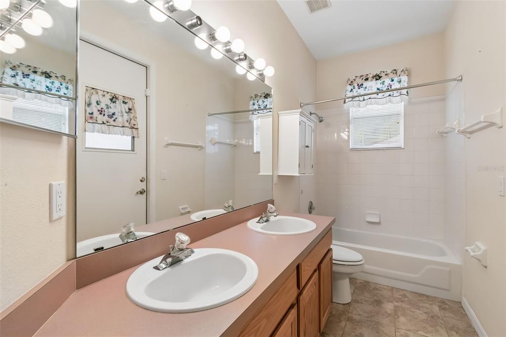 10118 Shortwood Lane Orlando, FL 32836 - Photo 36 of 53 a bathroom with a sink and a mirror