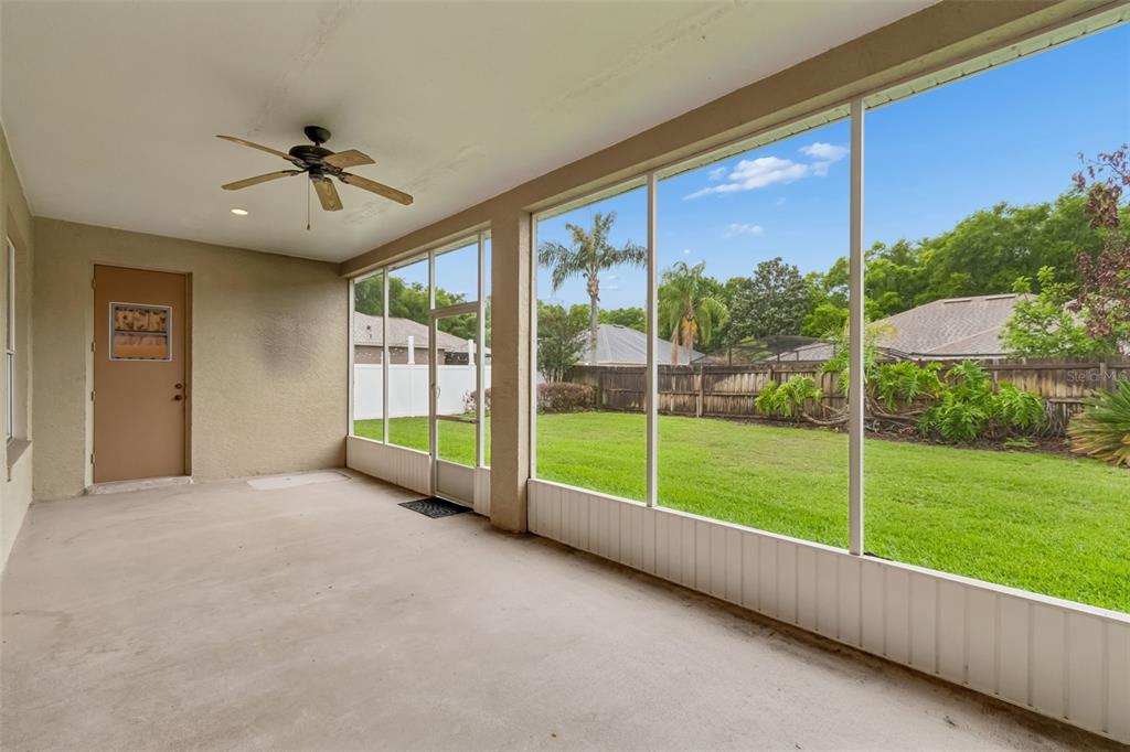 10118 Shortwood Lane Orlando, FL 32836 - Photo 39 of 53 a view of an empty room with windows and a ceiling fan