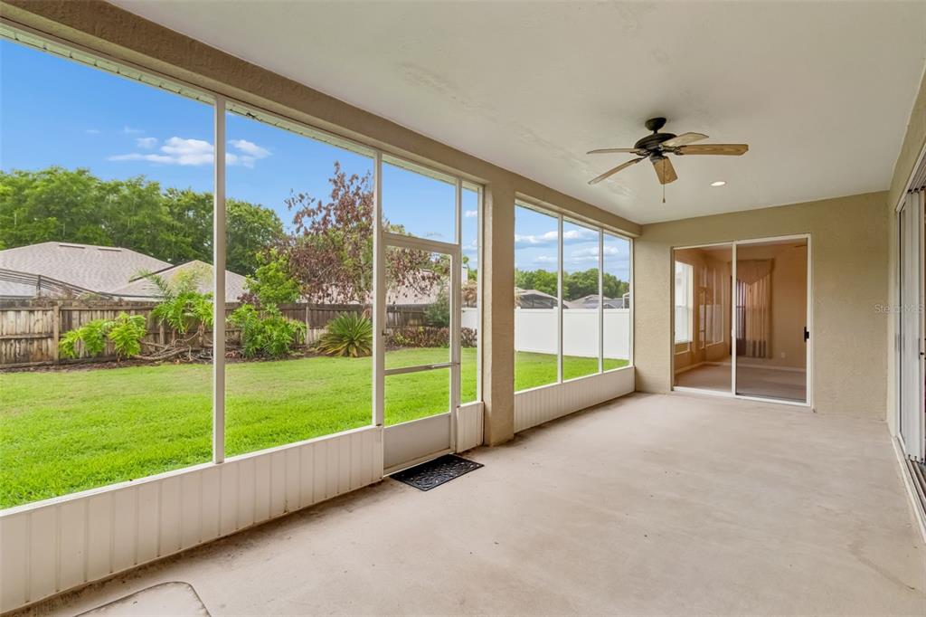 10118 Shortwood Lane Orlando, FL 32836 - Photo 42 of 53 a view of an empty room with a floor to ceiling window and a yard
