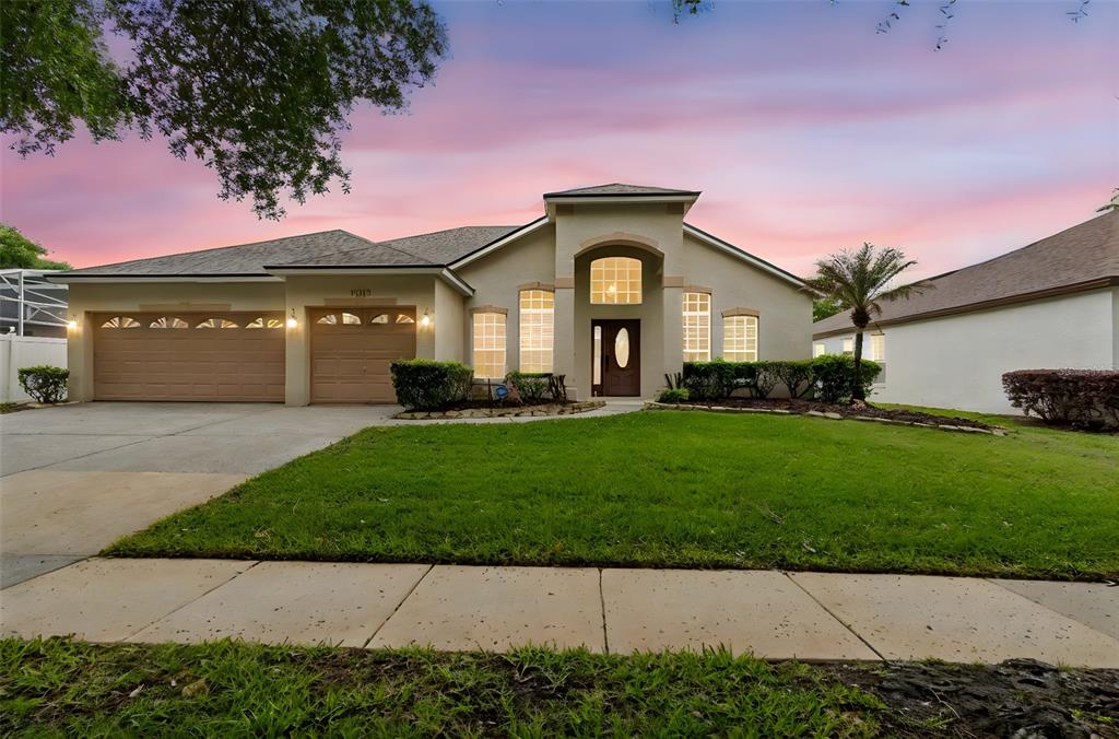 10118 Shortwood Lane Orlando, FL 32836 - Photo 53 of 53 a front view of a house with a garden and yard