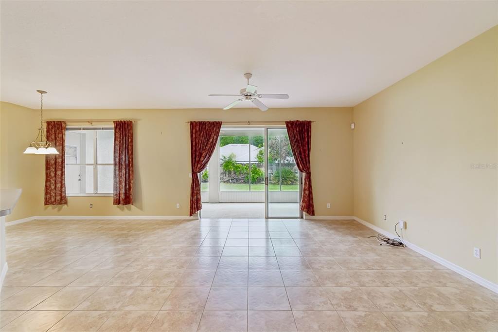 10118 Shortwood Lane Orlando, FL 32836 - Photo 7 of 53 a view of an empty room with wooden floor and a window