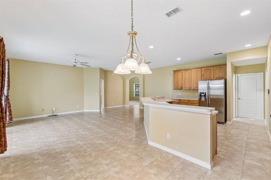 10118 Shortwood Lane Orlando, FL 32836 - Photo 9 of 53 a large kitchen with kitchen island a stove a sink dishwasher and a refrigerator