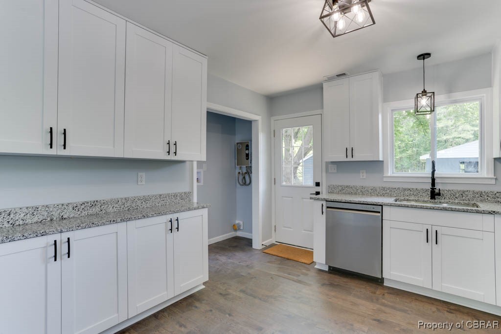 917 Chapel Neck Road North, VA 23128 - Photo 9 of 29 Kitchen with dishwasher, a sink, white cabinetry, wood finished floors, and baseboards