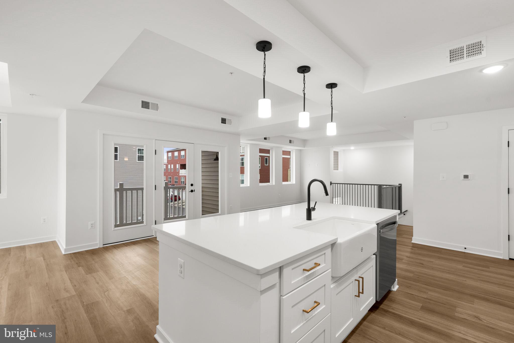 1631 Blacksmith Way, Unit 214B Frederick, MD 21702 - Photo 12 of 41 a kitchen with stainless steel appliances granite countertop a sink a refrigerator and a stove