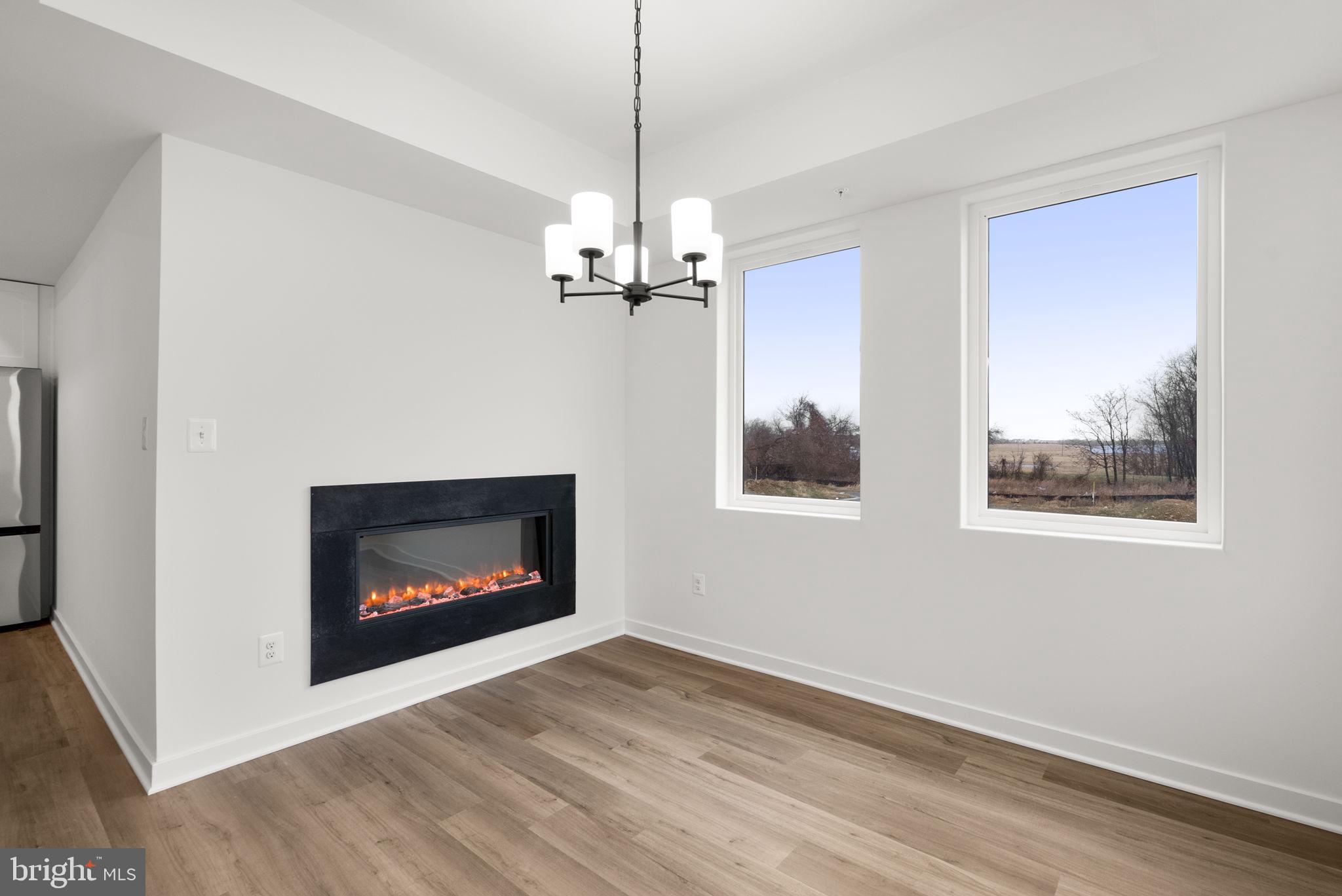 1631 Blacksmith Way, Unit 214B Frederick, MD 21702 - Photo 16 of 41 a living room with a fireplace