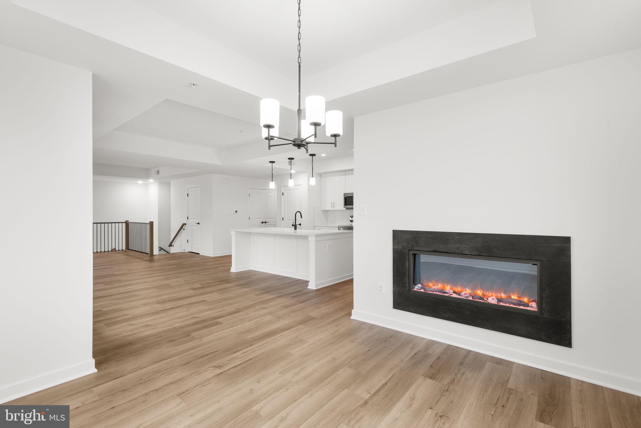 1631 Blacksmith Way, Unit 214B Frederick, MD 21702 - Photo 17 of 41 a view of kitchen with fireplace and wooden floor