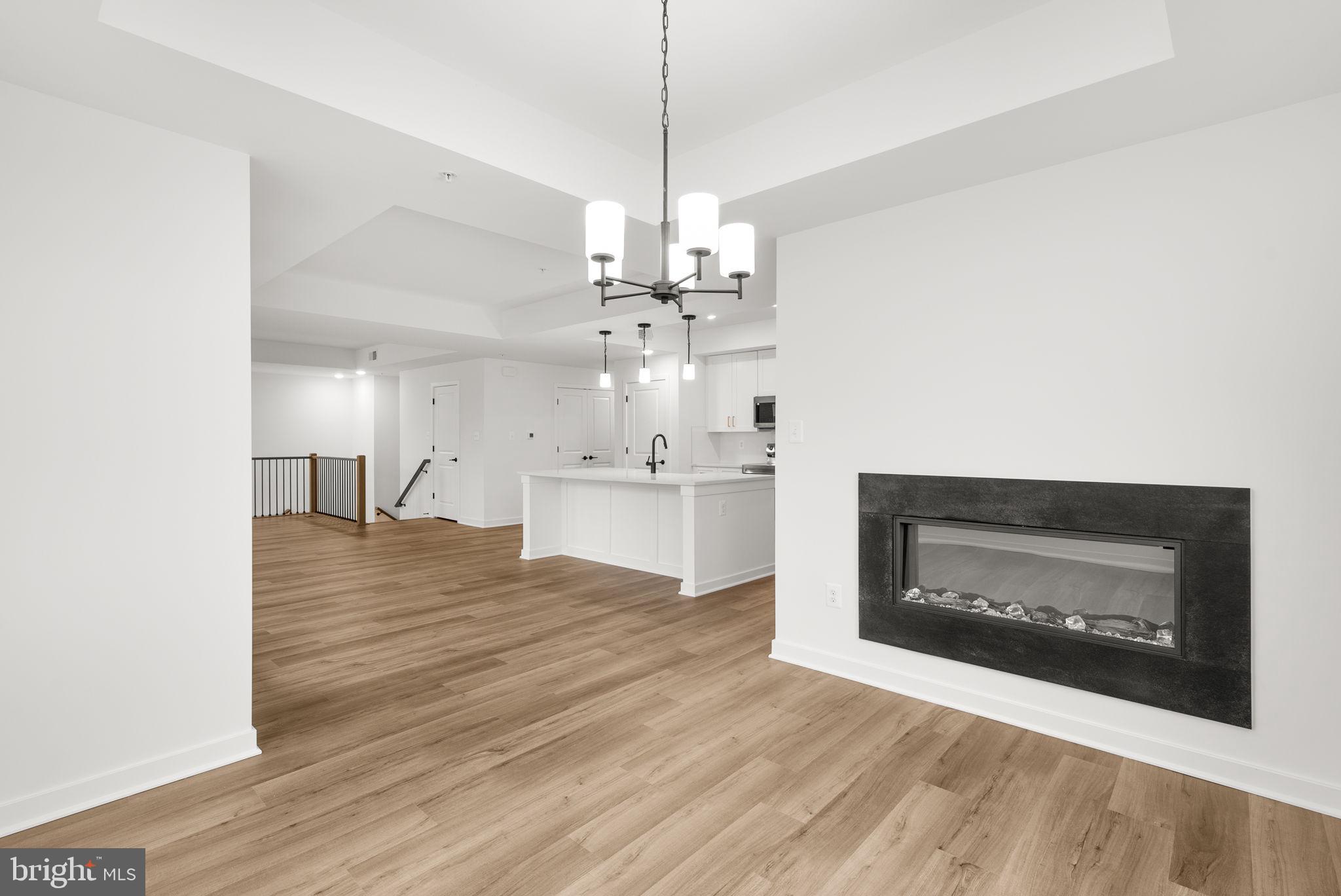1631 Blacksmith Way, Unit 214B Frederick, MD 21702 - Photo 18 of 41 a view of a kitchen with granite countertop fireplace and wooden floor