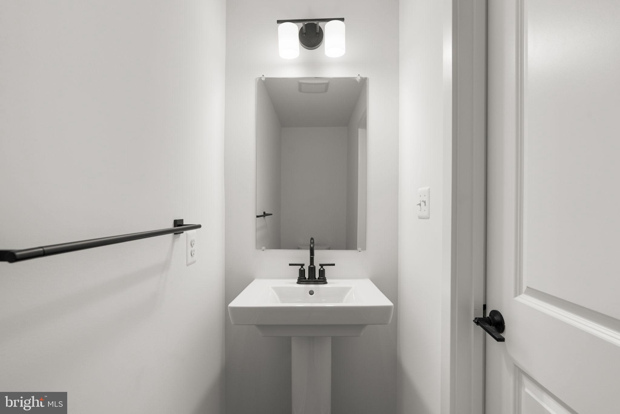 1631 Blacksmith Way, Unit 214B Frederick, MD 21702 - Photo 20 of 41 a bathroom with a sink and mirror