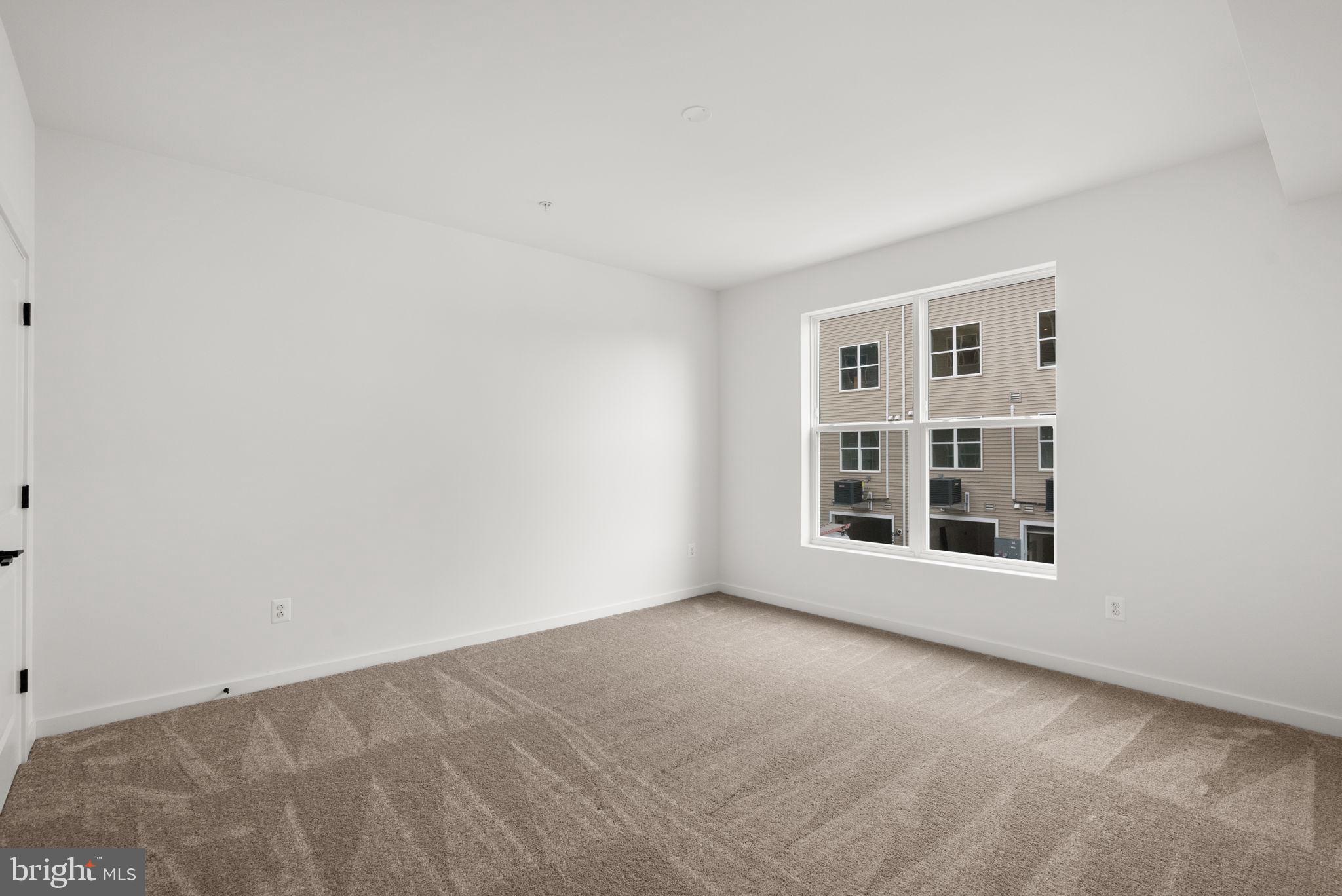 1631 Blacksmith Way, Unit 214B Frederick, MD 21702 - Photo 21 of 41 an empty room with windows